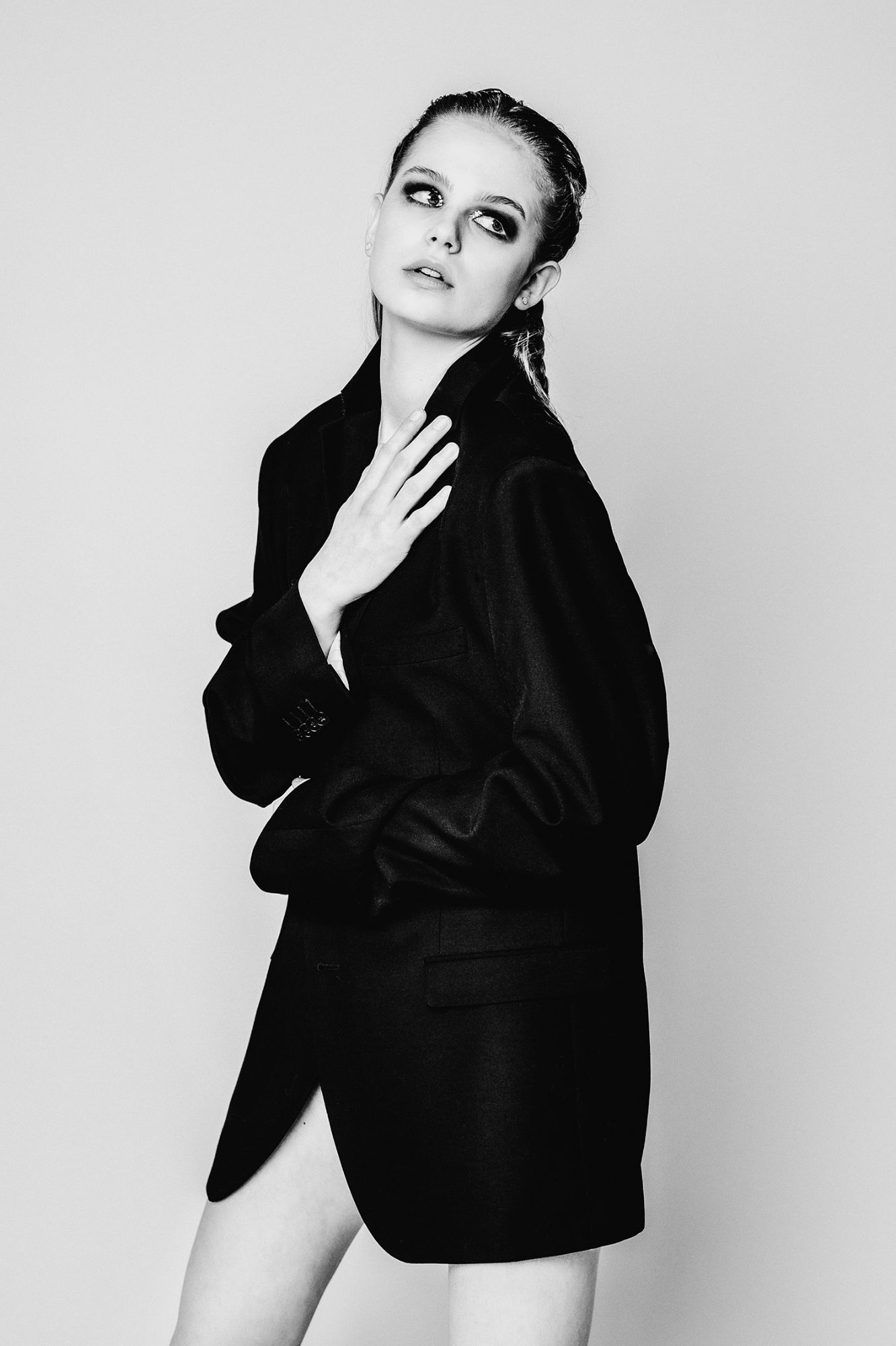 black and white image from a girl with a black blazer and dark makeup