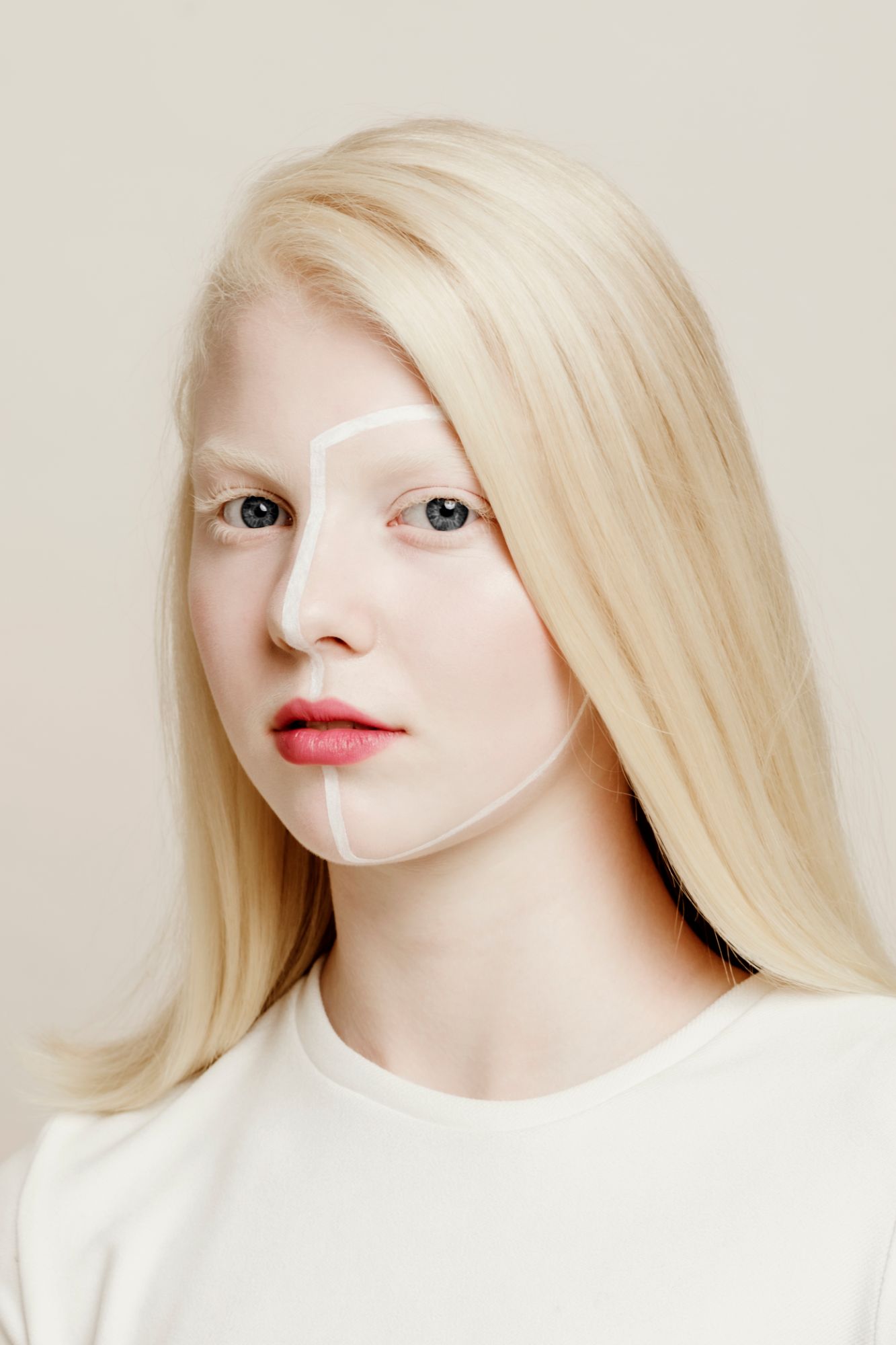 very light blonde girl portrait with white painted lines in her face